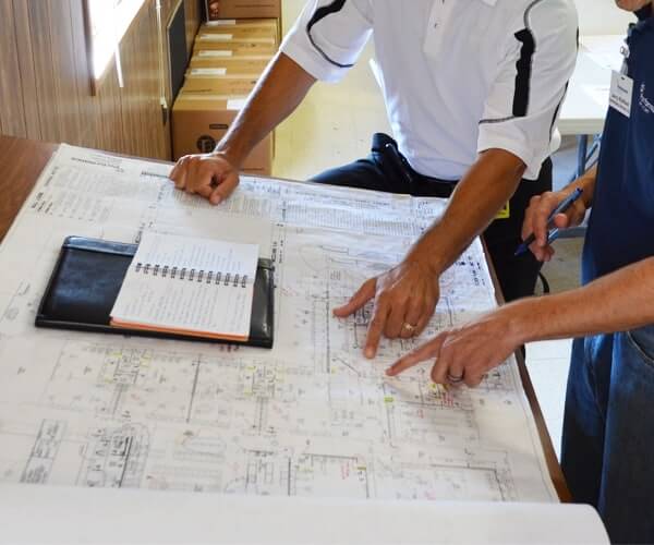 Two project team members reviewing floor plans