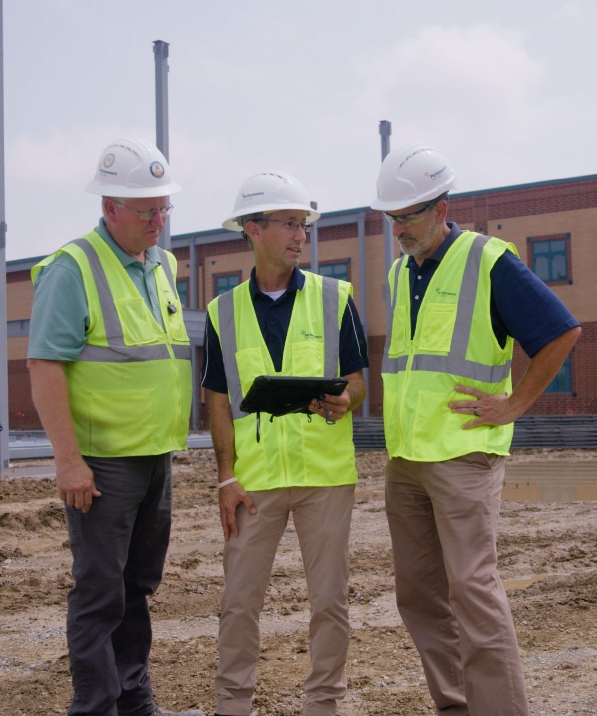 Performance Services team collaborating at a project site in proper PPE