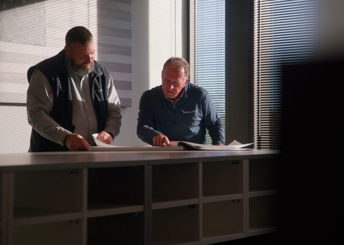 Performance Services team members reviewing plans for an energy savings project