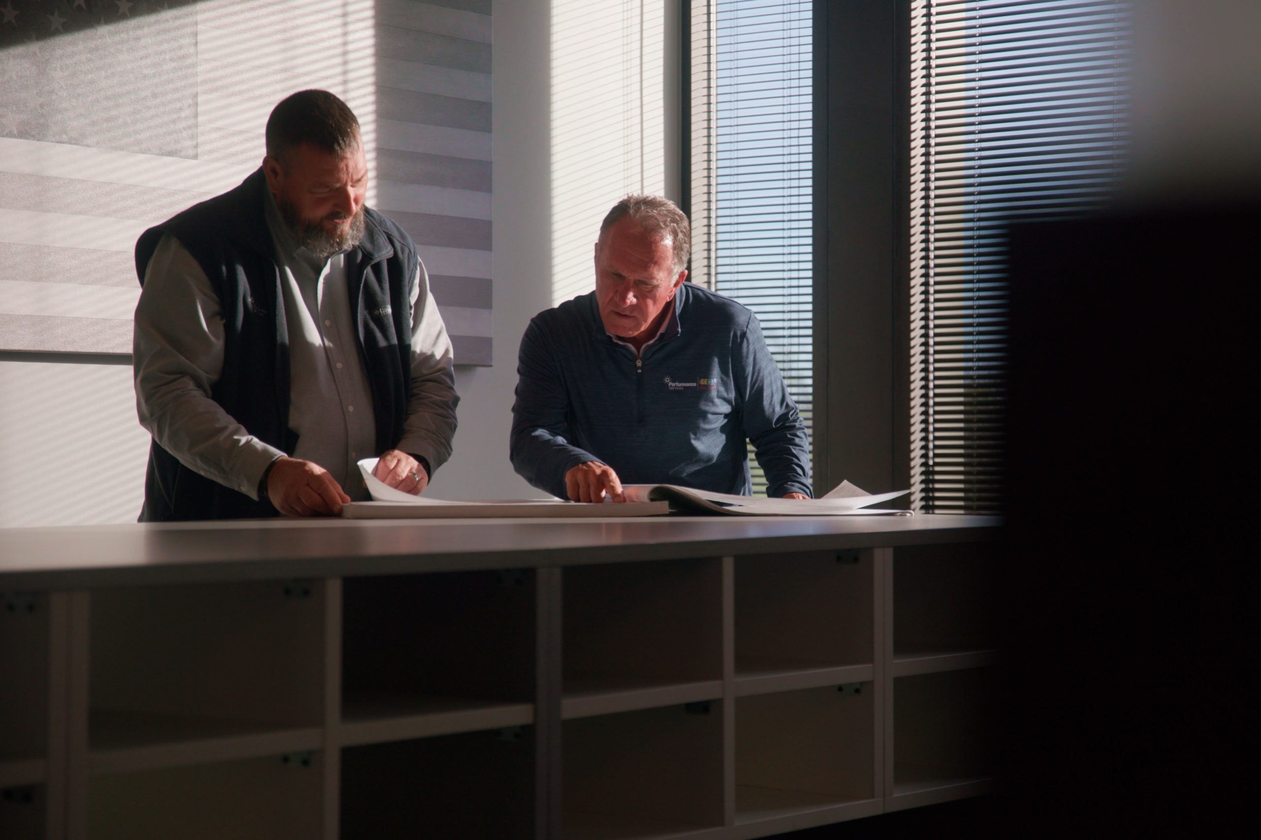 Performance Services team members reviewing plans for an energy savings project
