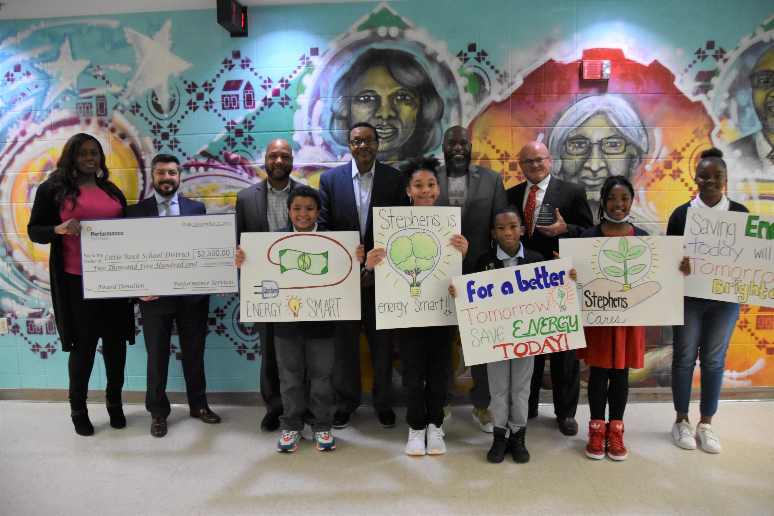 Student Leaders at Little Rock Schools Energy Leadership Program holding energy-related artwork