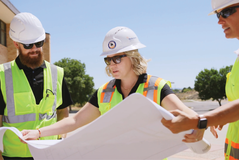 Performance Services team in PPE and looking at design-build construction plans