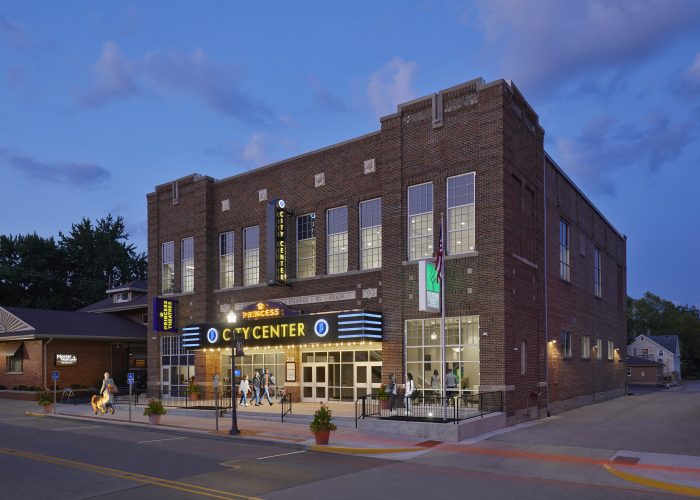 Exterior of the City of Rushville at sunset with people walking by