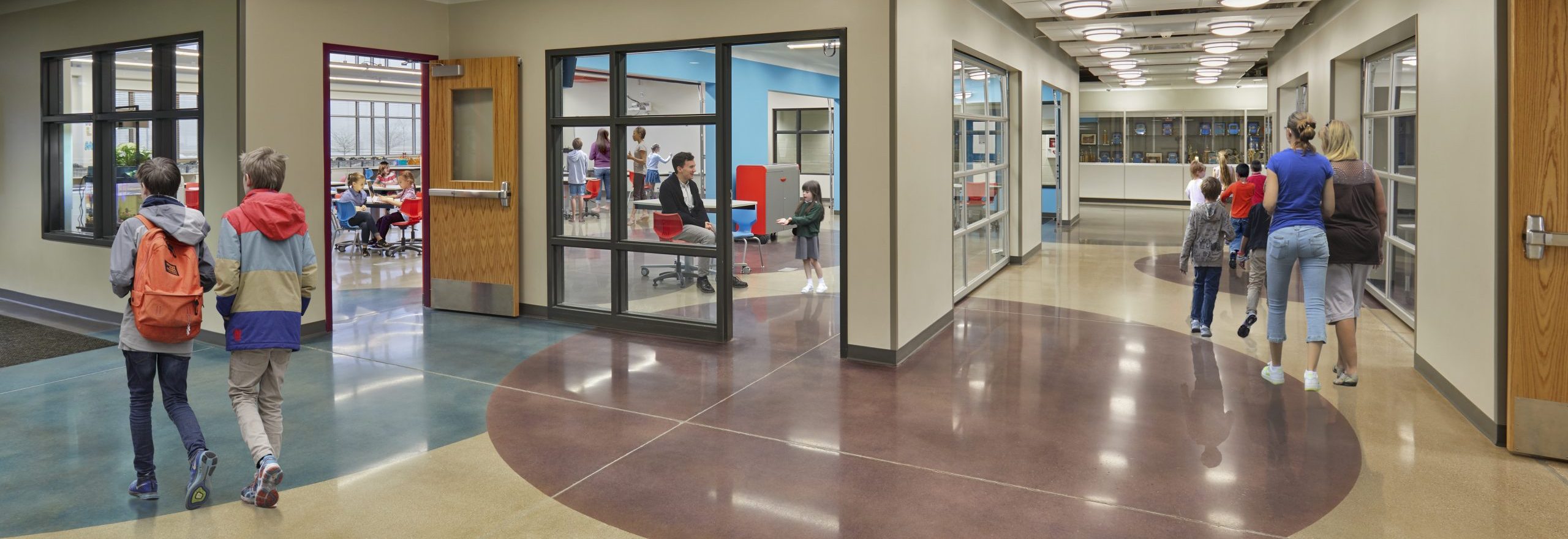 Students walking through the hallway of a school that was renovated using the design-build construction method