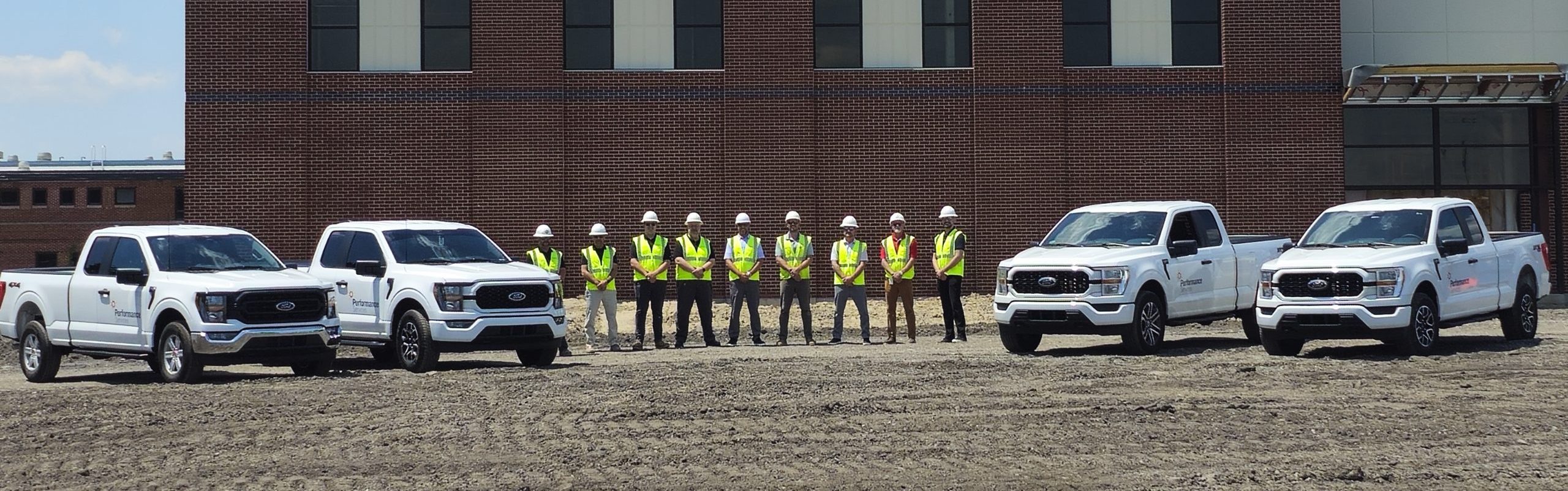 Performance Services project managers in safety vests and hard hats at a construction project