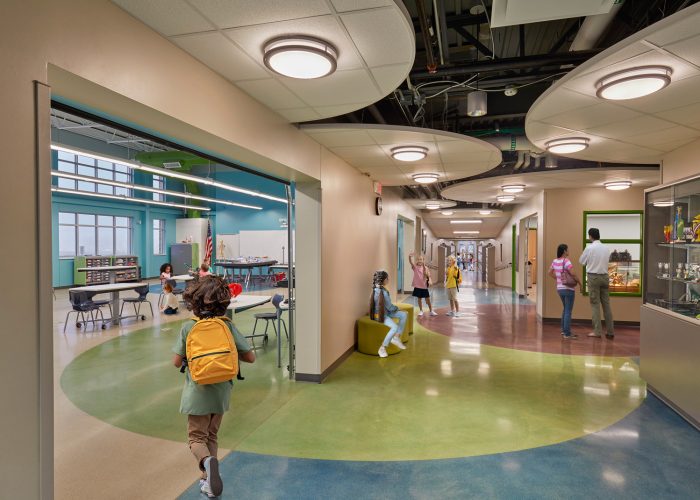 Students walking through the hallway of a school that was renovated using the design-build construction method
