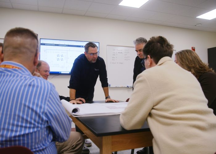 Team Gathered Around Talking About Construction