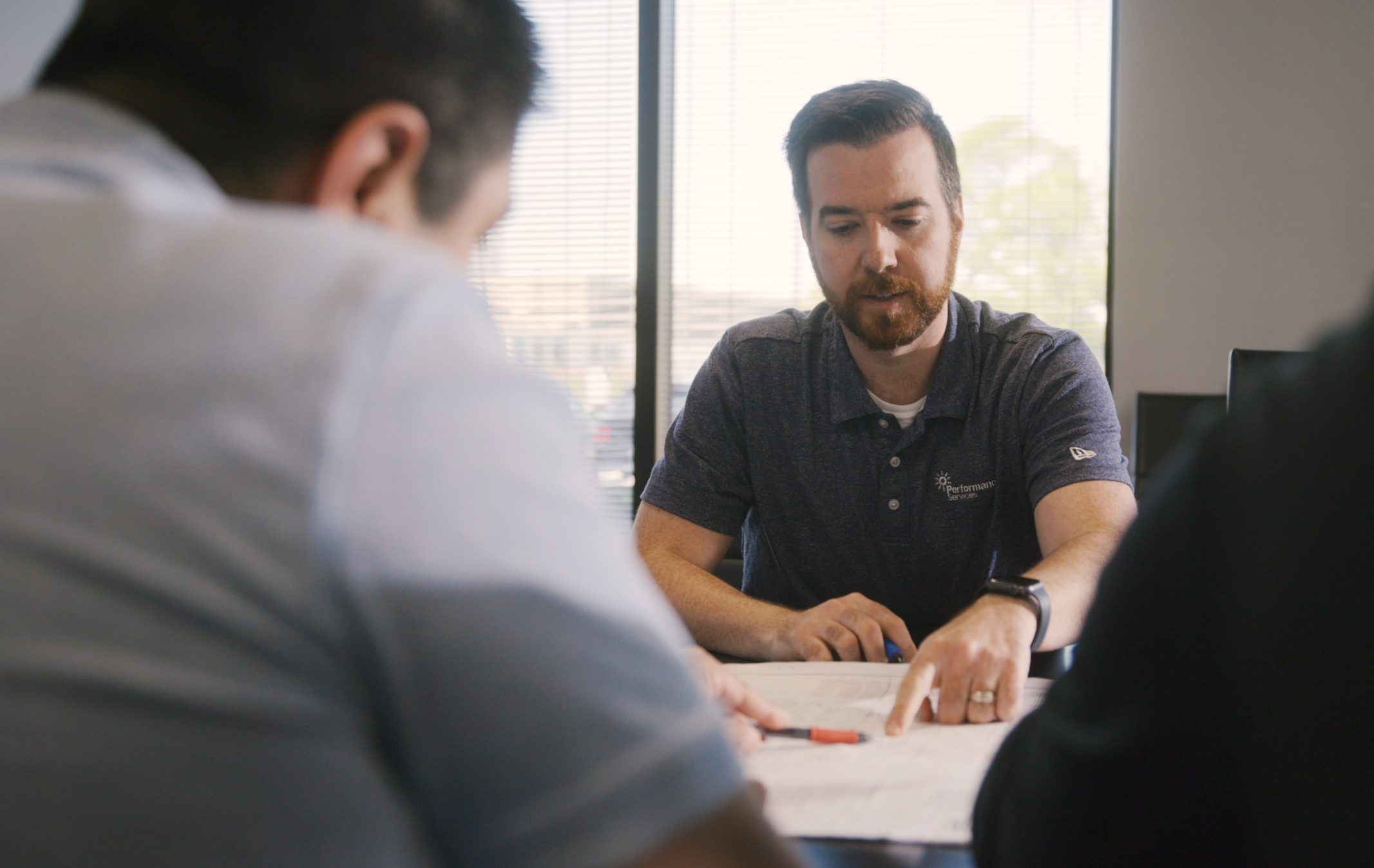 Performance Services engineer discussing project plans with teammates