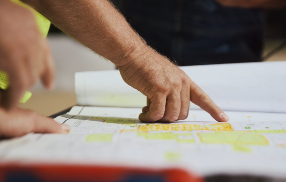 Performance Services project manager pointing at active project plans