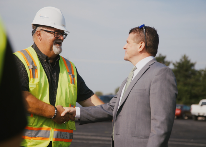 Customer shaking the hand of a Performance Services professional